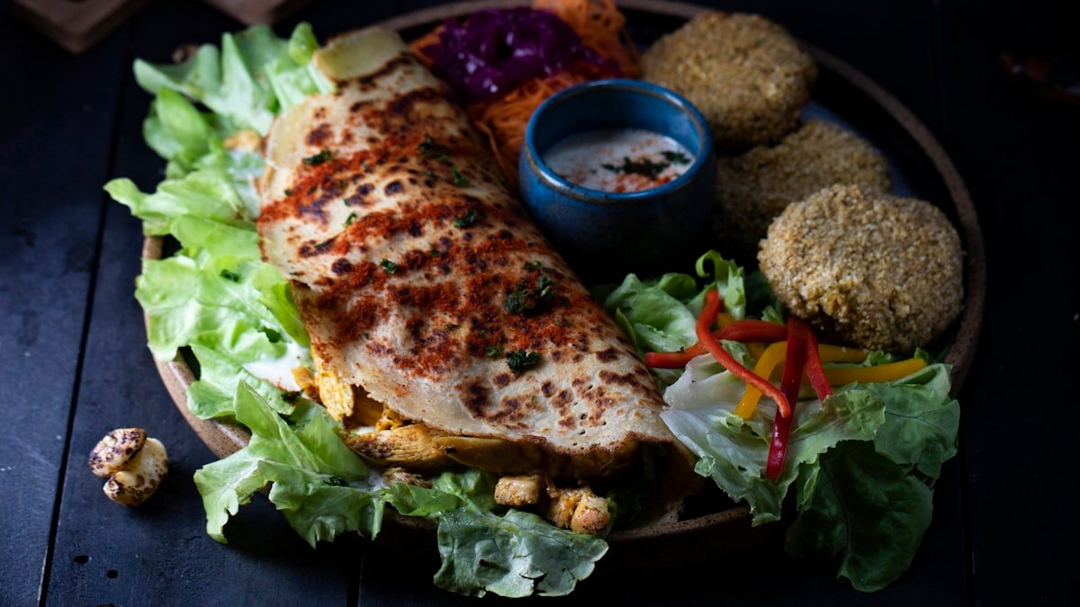 Fresh shawarma wrap with garlic sauce, pickles, and fries, the workhorse Levantine street food of Ajman
