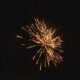 Fireworks lighting up the night sky over water