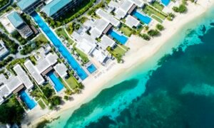 Aerial view of a luxury beachfront resort with turquoise water