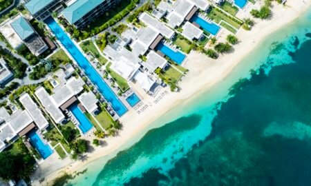 Aerial view of a luxury beachfront resort with turquoise water