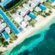 Aerial view of a luxury beachfront resort with turquoise water