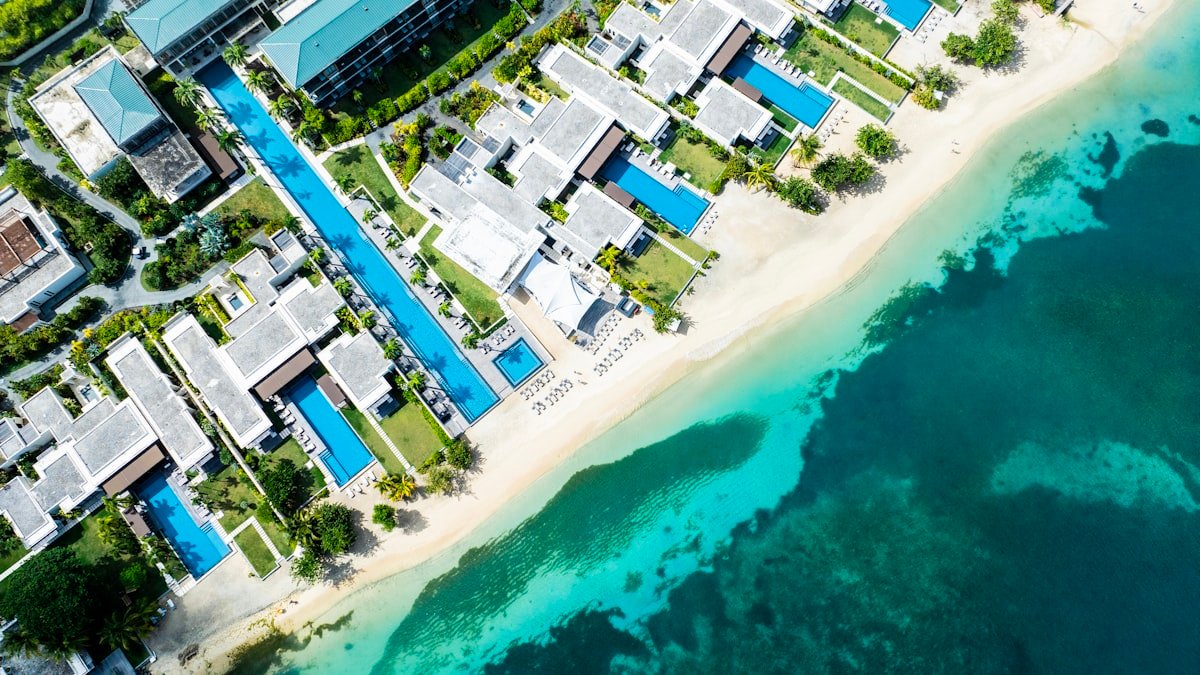 Aerial view of a luxury beachfront resort with turquoise water