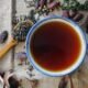 Glass cup of karak chai with steam rising and Middle Eastern flatbread, the staple morning and afternoon order in Ajman