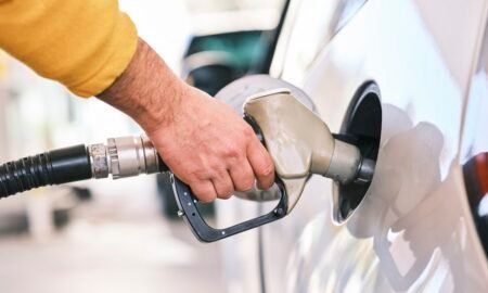 Close-up of a fuel nozzle filling a car at a petrol station