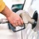 Close-up of a fuel nozzle filling a car at a petrol station