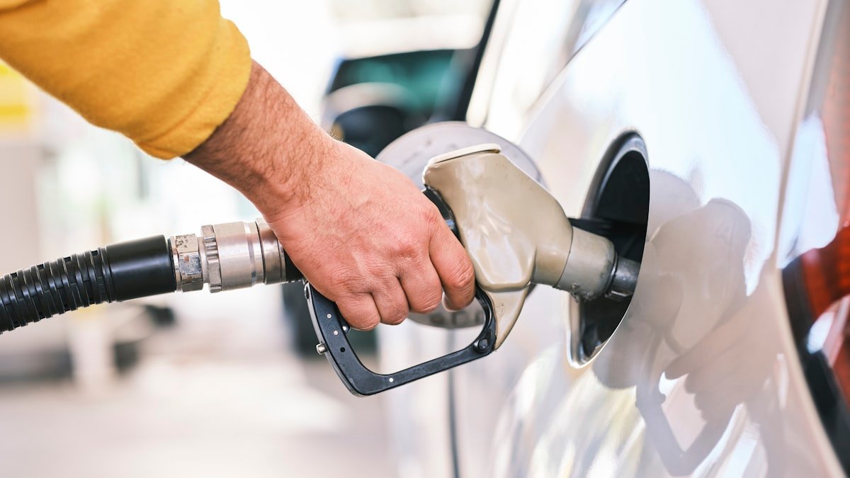 Close-up of a fuel nozzle filling a car at a petrol station