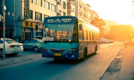An intercity coach on an open road at golden hour