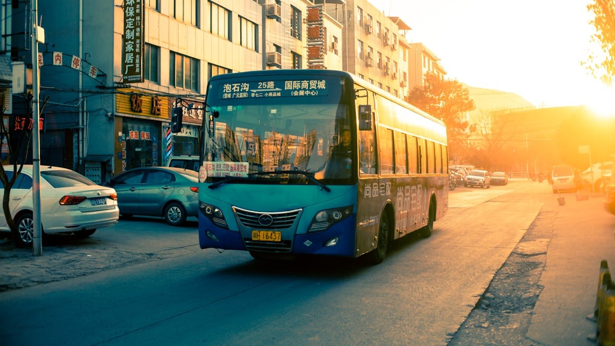 An intercity coach on an open road at golden hour