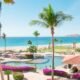 Sun loungers beside a resort pool on a sunny day