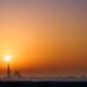 Ajman skyline at sunset with residential apartment towers along the coast