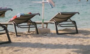 Sun loungers and an umbrella on a resort beach at golden hour